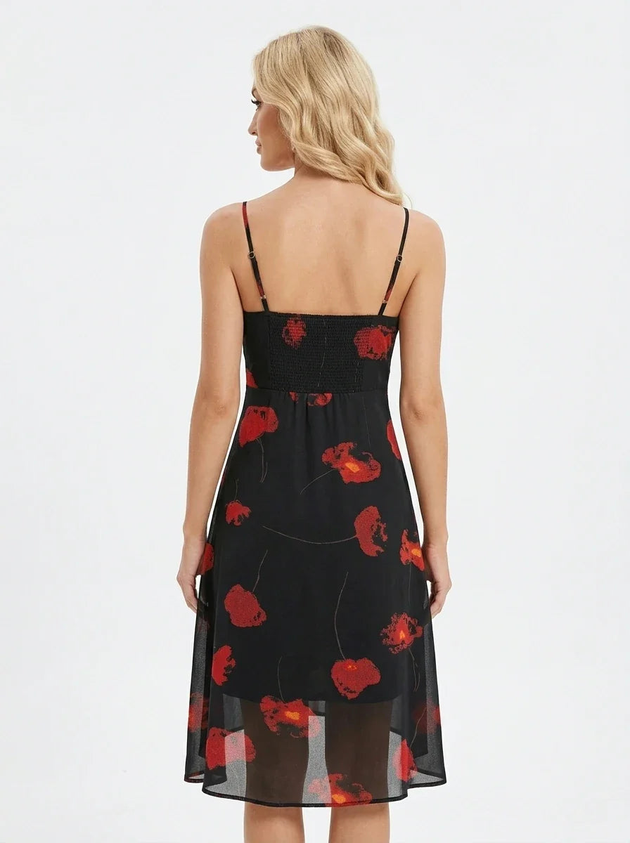 Back view of a woman in a black sleeveless midi dress with a red floral print.