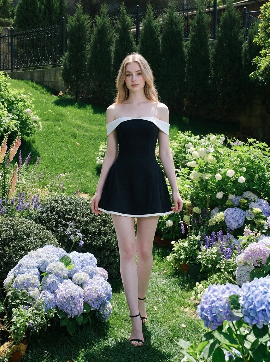 woman in black and white off-the-shoulder dress walking in garden with hydrangeas