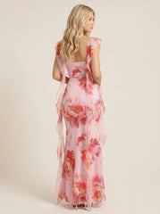 Back view of a woman in a pink floral print maxi dress with ruffle trim