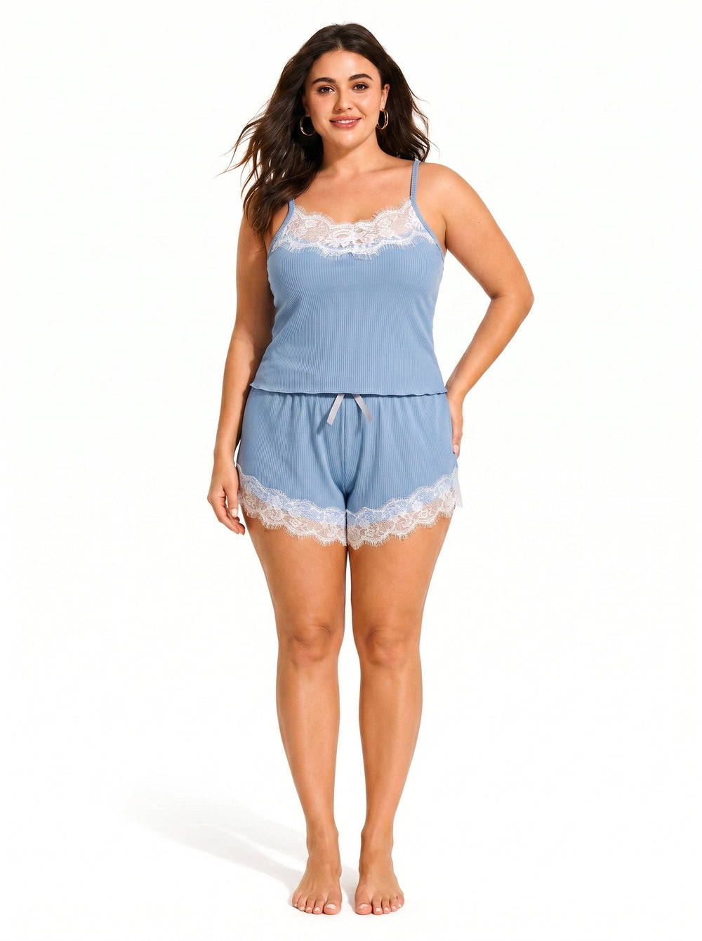Woman wearing a blue ribbed knit camisole pajama top with white lace trim and adjustable spaghetti straps.