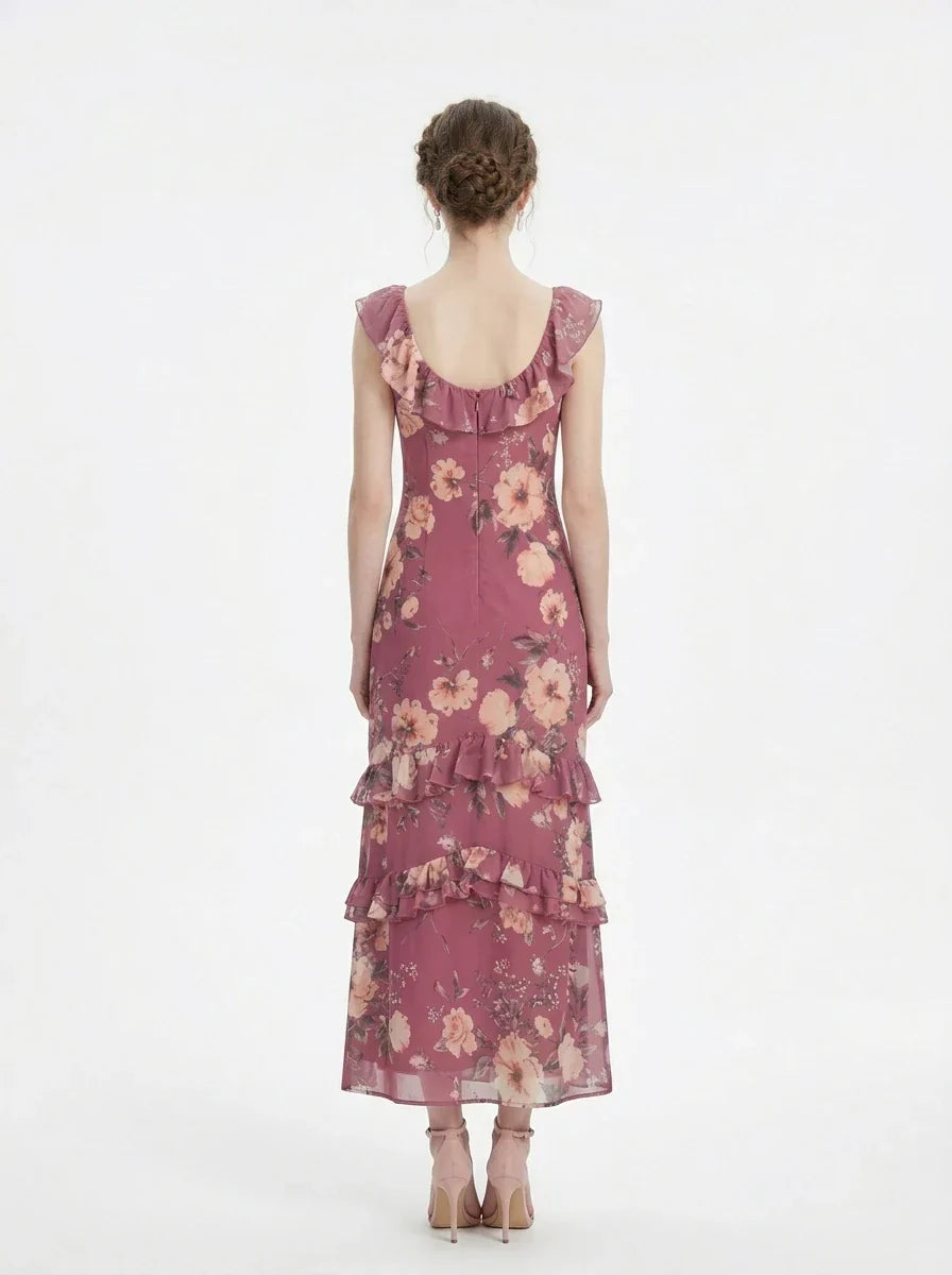 Woman wearing a pink floral print maxi dress with ruffle trim, back view