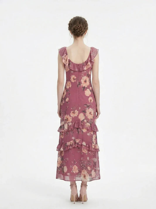 Woman wearing a pink floral print maxi dress with ruffle trim, back view