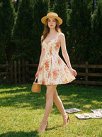 Woman walking in a garden wearing a floral print fit and flare dress and a straw hat