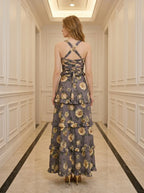 Back view of a woman in a floral print maxi dress with a lace-up back
