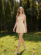 Woman wearing a yellow floral print mini dress with spaghetti straps and a sweetheart neckline walking across a lawn in a park.