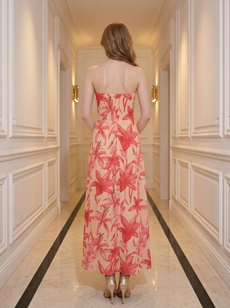 Back view of a woman in a strapless floral print midi dress.