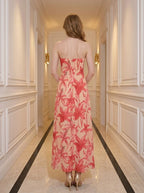 Back view of a woman in a strapless floral print midi dress.