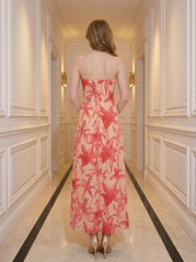 Back view of a woman in a strapless floral print midi dress.