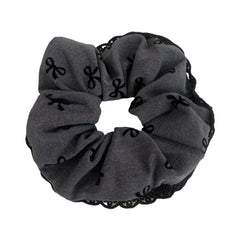 grey scrunchie with black bow pattern and lace trim