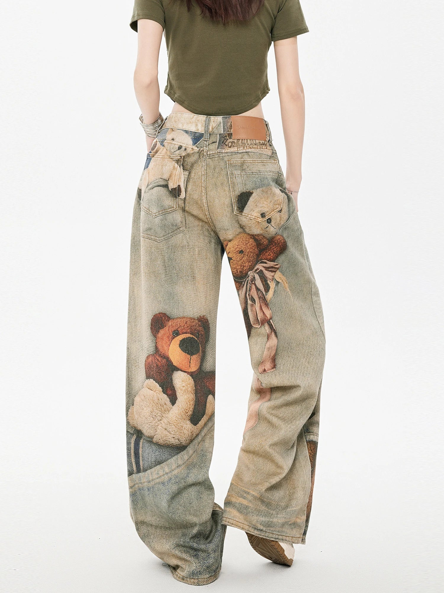 Back view of wide leg jeans with teddy bear graphic print and tie waist