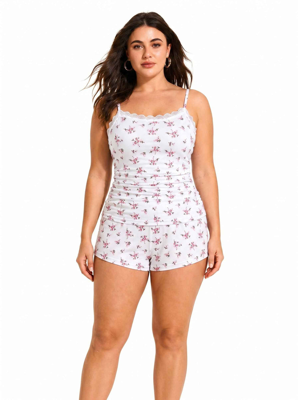 Woman wearing white floral print pajama camisole and shorts set