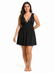 Woman wearing a black lace-trimmed babydoll nightgown from the front