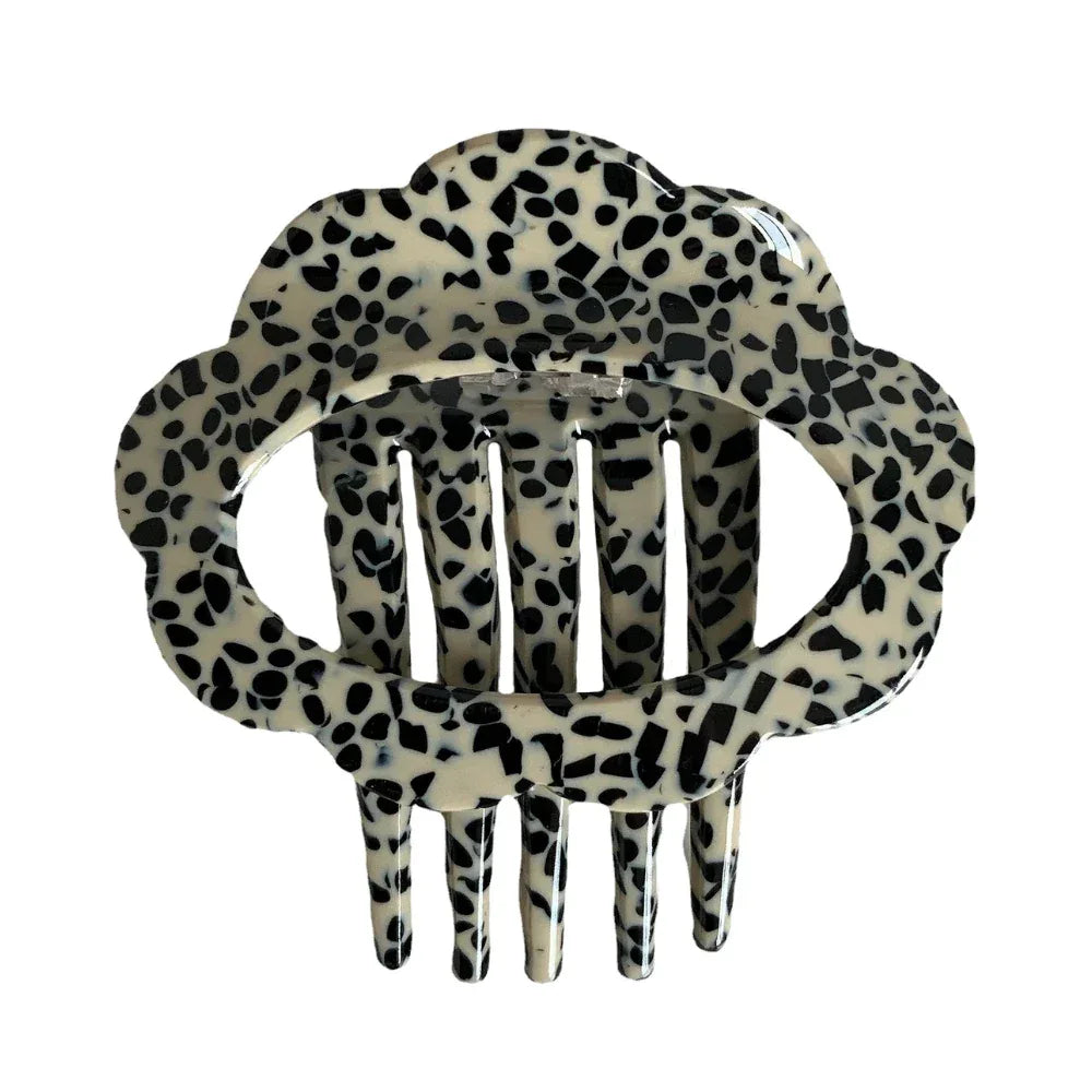 A single black and white dalmatian print cloud hair clip