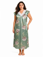 Woman wearing a green floral satin nightgown with lace trim
