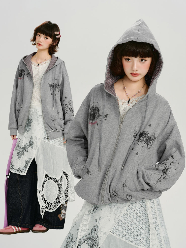 Split image showing a young woman in a grey zip-up hoodie with a graphic print and white lace skirt, and a separate image of the same hoodie with the hood up.