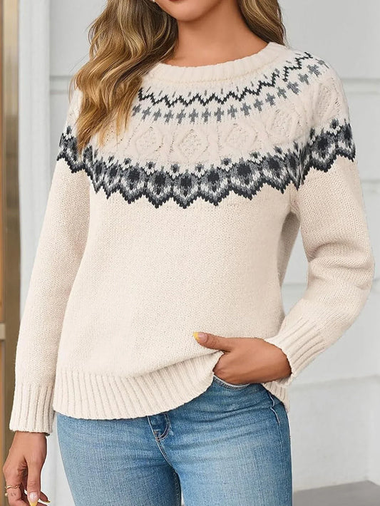 Woman wearing a cream-colored knit sweater with a Fair Isle pattern around the yoke and blue jeans.