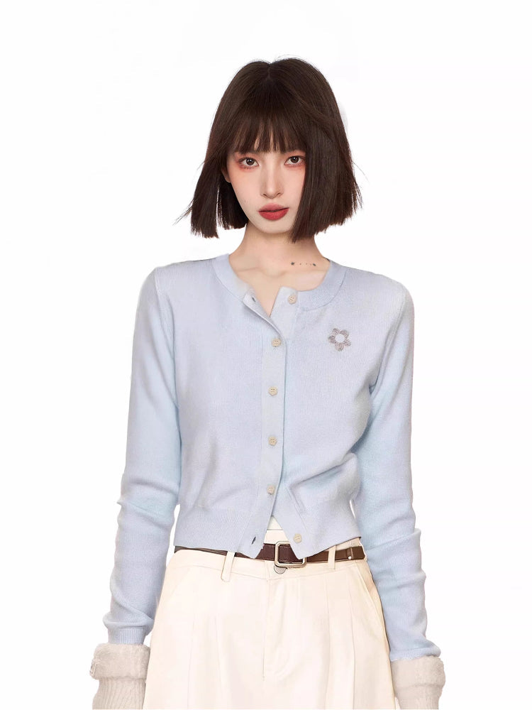 Light blue knit cardigan with embroidered detail and button-up closure