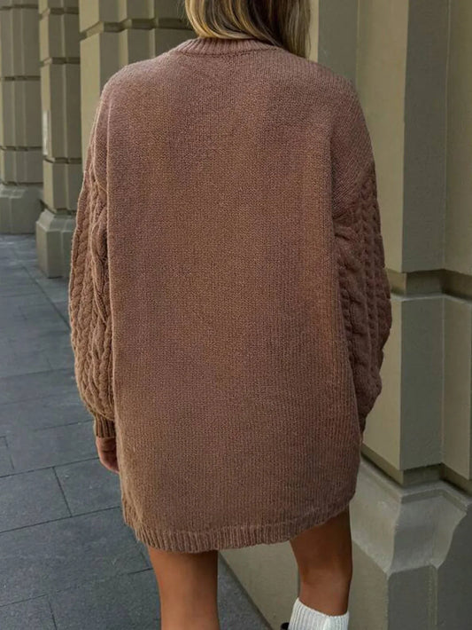 Back view of a woman in a brown cable knit sweater dress.