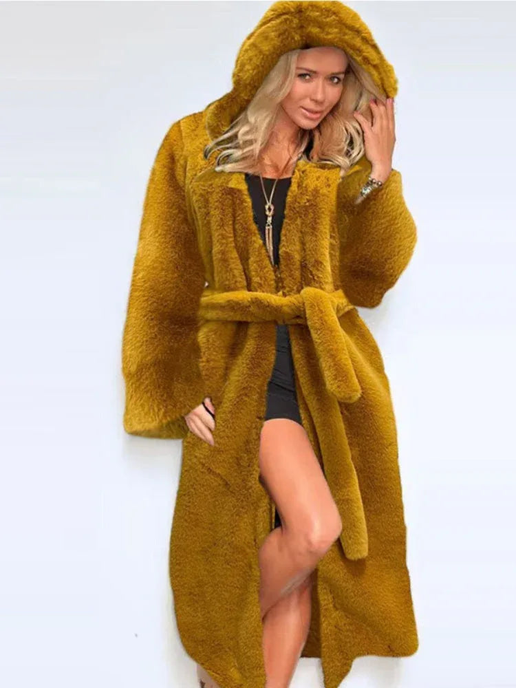 Woman wearing a long, mustard yellow faux fur coat with a hood and belt