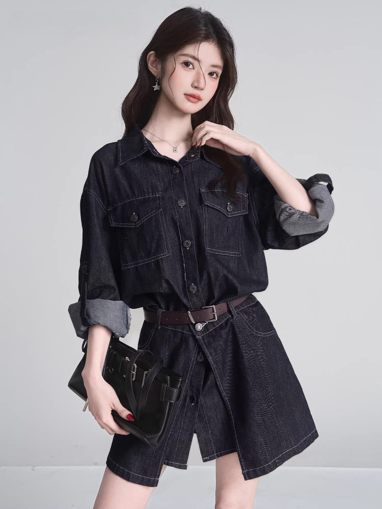 Close-up of a woman wearing a dark wash denim shirt dress with a brown belt, holding a black handbag.