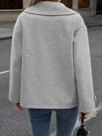 Back view of a woman wearing a grey peacoat.