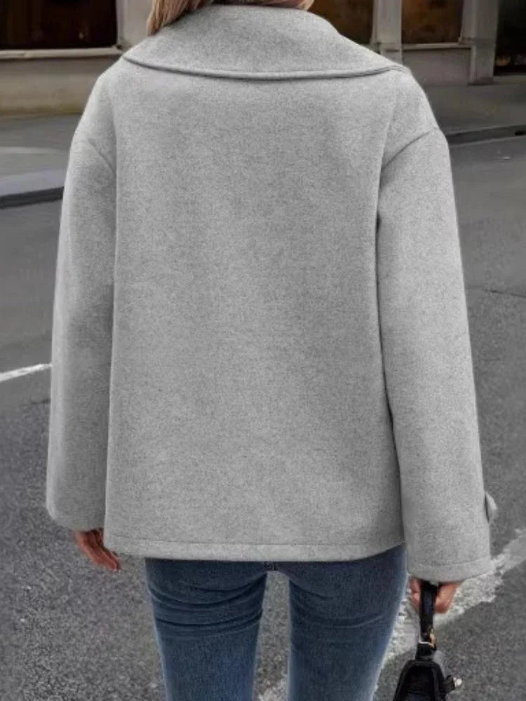 Back view of a woman wearing a grey peacoat.