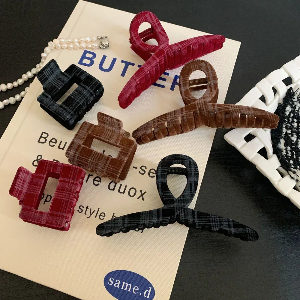 Flat lay of plaid velvet hair clips and a pearl necklace