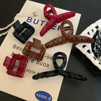 Flat lay of plaid velvet hair clips and a pearl necklace