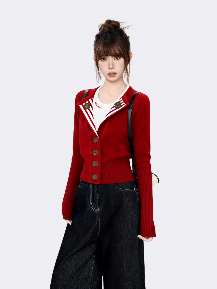 Woman wearing a red knit cardigan over a white t-shirt and dark wash wide-leg jeans, with a black backpack