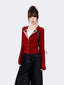 Woman wearing a red knit cardigan over a white t-shirt and dark wash wide-leg jeans, with a black backpack