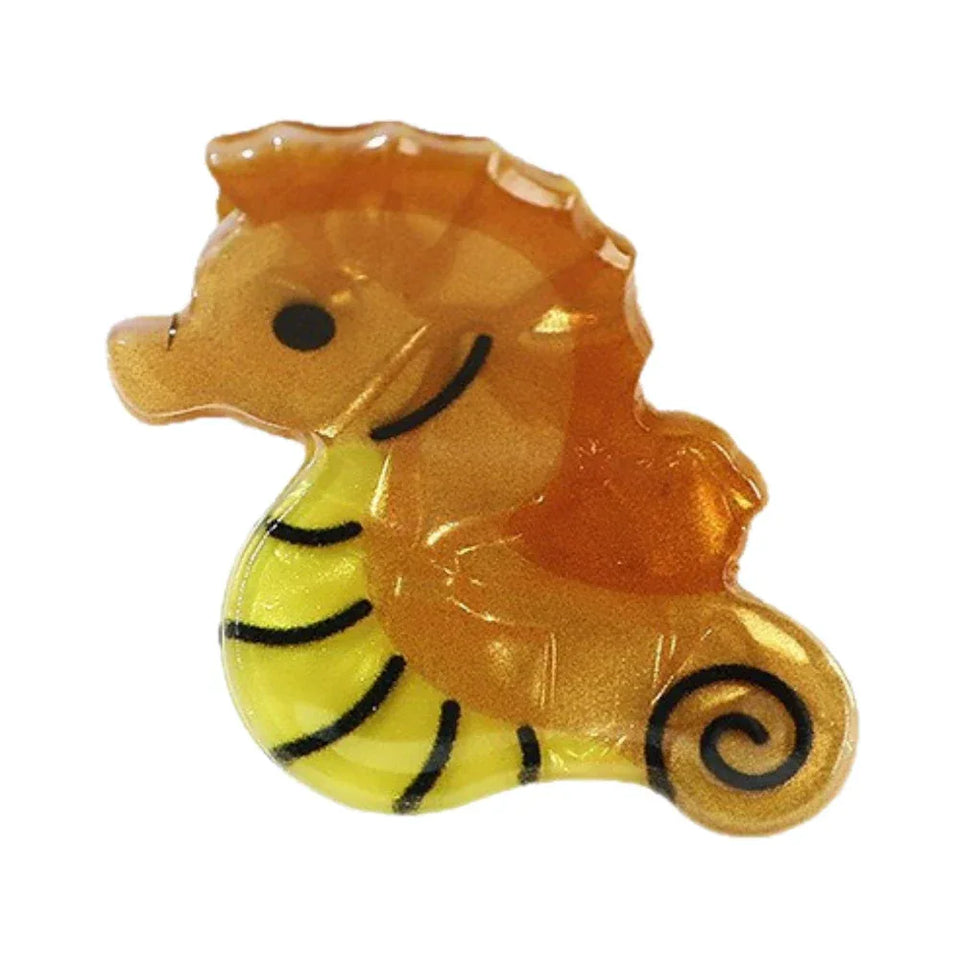A single golden seahorse hair clip with black stripes. Main image