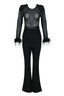 A black sequined mesh long-sleeved top with feathered cuffs and black velvet flared pants laid flat.