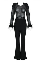 A black sequined mesh long-sleeved top with feathered cuffs and black velvet flared pants laid flat.