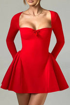 Model in a red long-sleeved square neck mini dress