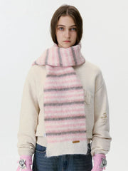 Woman wearing a pink and grey striped fuzzy scarf