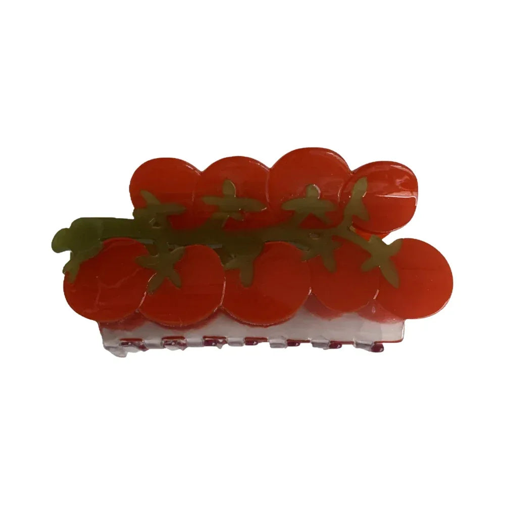 A close-up studio shot of a hair claw shaped like a bunch of cherry tomatoes on a vine, against a white background. Main image