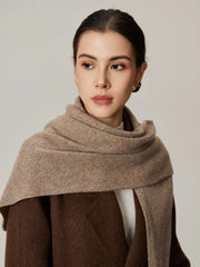 Woman wearing a beige scarf draped around her neck, front view