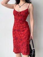 Side view of a red floral print midi dress with a fit and flare silhouette.
