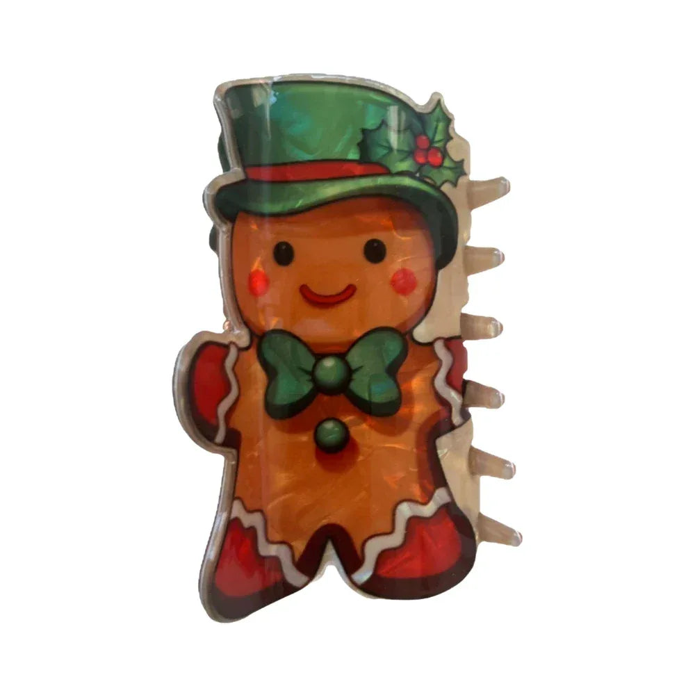 Gingerbread man hair claw clip with a green top hat and holly accents. Main image
