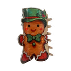 Gingerbread man hair claw clip with a green top hat and holly accents.