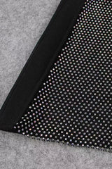Close-up of the sheer mesh panel with rhinestone embellishments on the leg of the black jumpsuit.