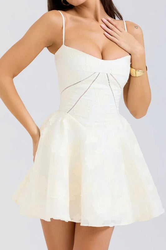 Front view of a woman in a cream-colored dress, showing the sweetheart neckline and detailed bodice.
