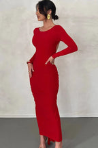 woman from the side in a red ruched dress