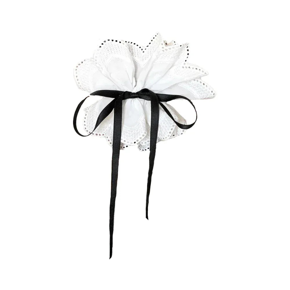 white lace hair accessory with black ribbon bow