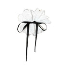 white lace hair accessory with black ribbon bow