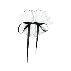 white lace hair accessory with black ribbon bow