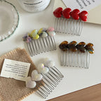 Heart-shaped hair combs arranged on a table with decorative elements