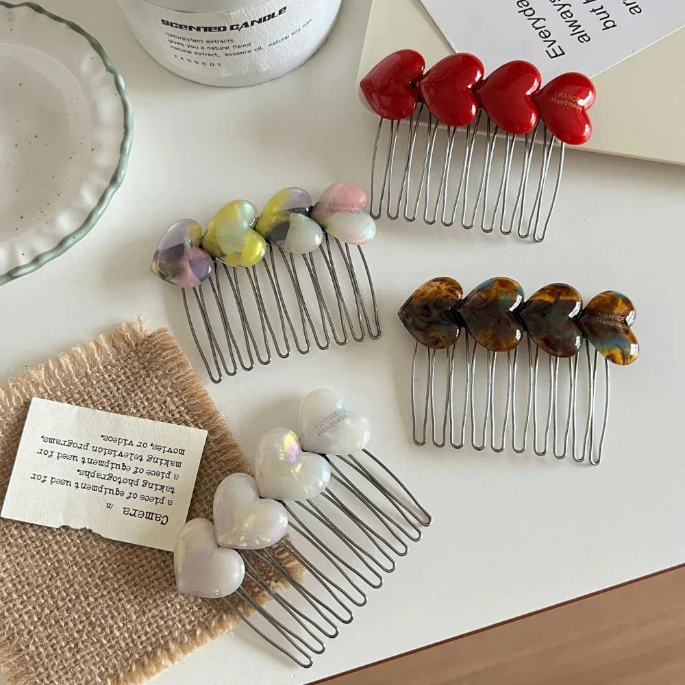Heart-shaped hair combs arranged on a table with decorative elements