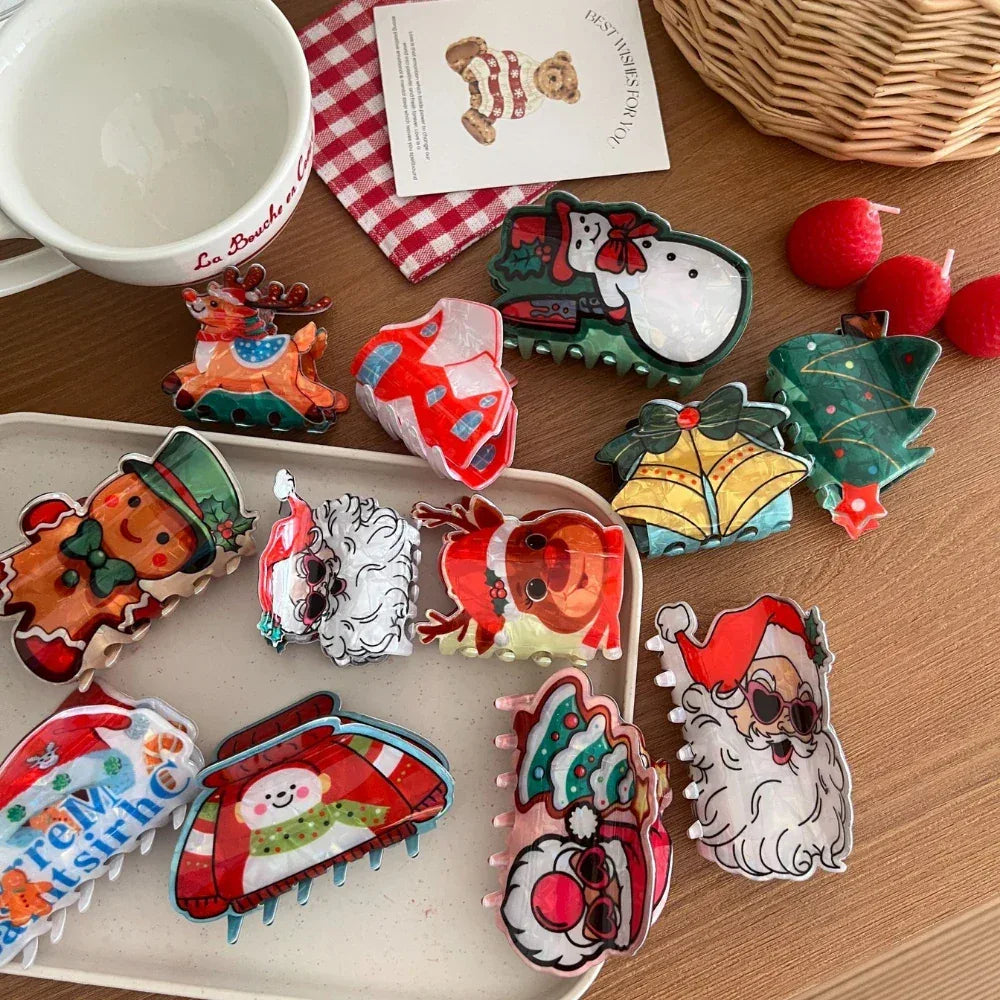 Collection of festive Christmas-themed hair claw clips arranged on a tray and a wooden surface.