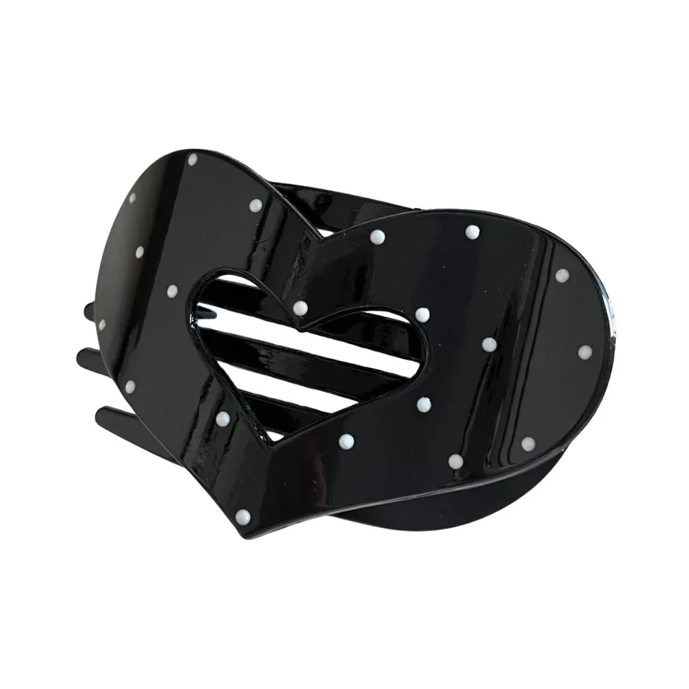Black heart-shaped hair claw clip with white polka dots and a cut-out heart detail.